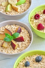 Sweet delicious healthy breakfast. Different porridge with fruit on a wooden kitchen table.