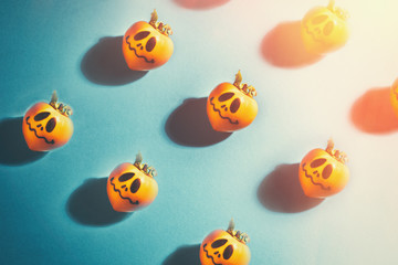 Halloween concept. Scary pumpkins on blue background, flat lay