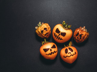 Family generation Halloween concept. Festive still life  pumpkins family on black background. Top view flat lay with copy space