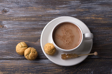 Freshly baked snickerdoodle cookies with cinnamon and nuts, hot chocolate on wooden background, top view. traditional american cookies