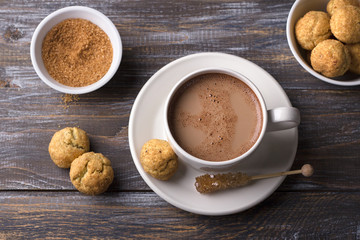 Freshly baked snickerdoodle cookies with cinnamon and nuts, hot chocolate on wooden background, top view. traditional american cookies