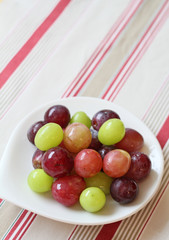 Some grapes and muscats on white dish