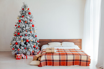 Christmas tree in the bedroom with bed and gifts holiday new year