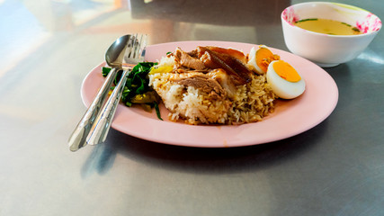 Stewed pork leg and egg with rice and vegetable with spicy sour sauce