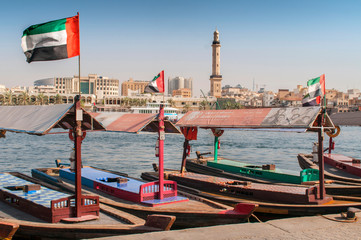 Fototapeta na wymiar Old traditional boats on the bay Creek in Dubai, United Arab Emirates.