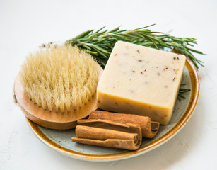Clean beauty.Spa products with rosemary herb, natural cinnamon soap and brush, natural home skincare products