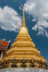Fototapeta premium Demons guard the bottom of a gilded Phra Mondop at the temple of the Emerald Buddha (Wat Phra Kaeo), Grand Palace, Bangkok, Thailand.