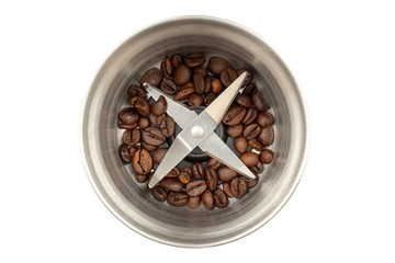 Steel coffee grinder with a small amount of coffee beans isolated on white background. Blade top view