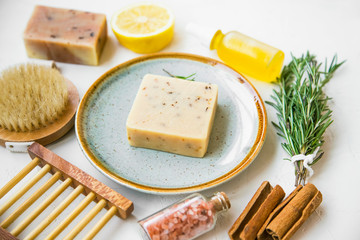 Natural spa products with handmade soap, bath salt, body brush, essential oil, herbs and natural ingredients, natural clean beauty products closeup