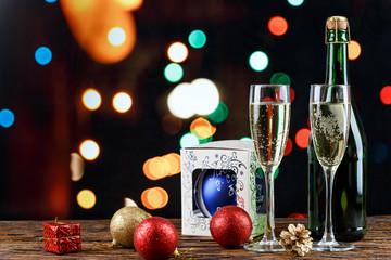 Fototapeta na wymiar champagne in glasses and with a Christmas toy
