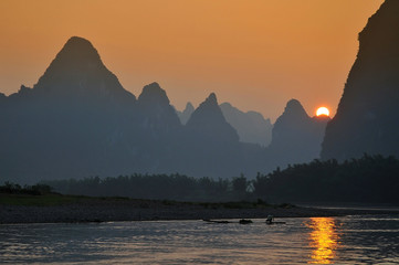 Scenic sunset over Karst mountains formations in Guilin, one of China most popular tourist destinations.