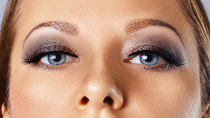 Woman eyes with long eyelashes and smokey eyes make-up. Eyelash extensions, makeup, cosmetics,...