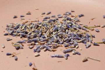 Dried blue lavender flowers with ceramic brown plate macro
