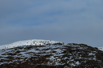 Mountains tops with snow and clouds