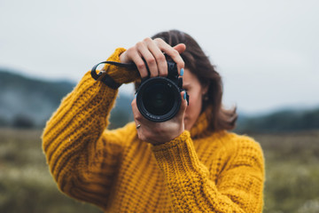 photographer girl take photo on camera closeup on background autumn foggy mountain, tourist...