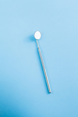 dentist tools on blue background: Dental Hygiene and Health conceptual image
