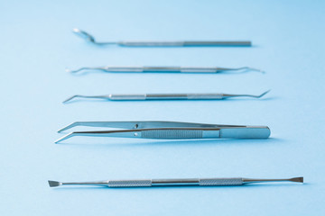 dentist tools on blue background: Dental Hygiene and Health conceptual image