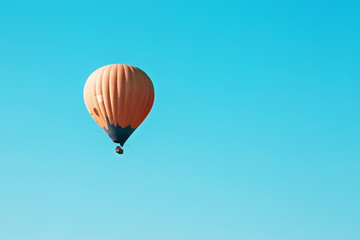 Obraz premium Orange balloon soars against the blue sky