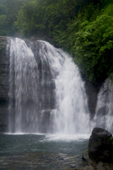 Fototapeta premium Waterfall of the hills of Shillong in Meghalaya, silky blur water and natural surroundings with trees.