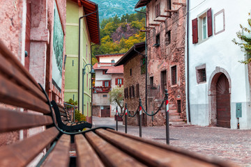 Fototapeta na wymiar Old small stone street in Italy. City of Ranzo province of Trento. The background is in focus, the foreground is blurred.