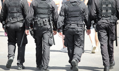 four men with bulletproof vest on the city