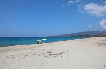 Fototapeta na wymiar beach of an Europea Island with sunshade and the sea