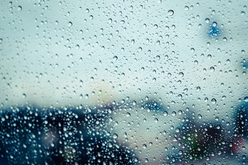 Naklejka na ściany i meble Close up raindrops on window with blur background.