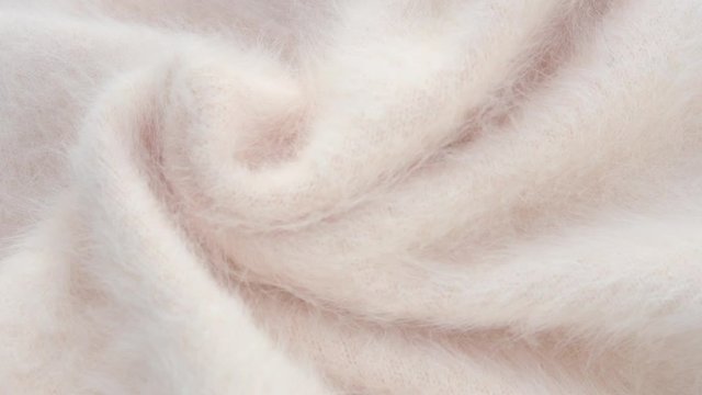 Soft fluffy jersey rotates. Soft Wool background.