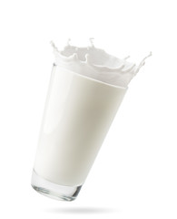 Glass of milk with splashes flies in the air on a white background, isolated. - 298314114