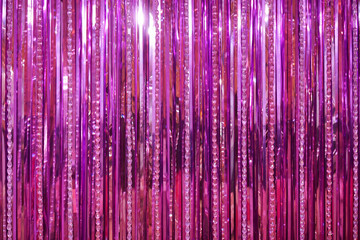 pink background. A closed up photo of pink background curtain made from foil paper and beads for...
