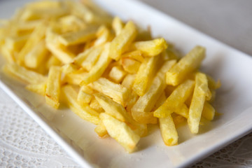chips (french fries) in white dish