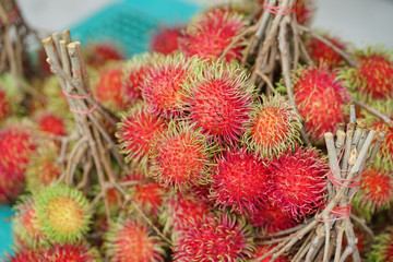 Rambutan. Fresh piles of rambutan selling in the fruit market. Rambutan is a tropical fruit, native to Indonesia and other South East Asian countries including Thailand.