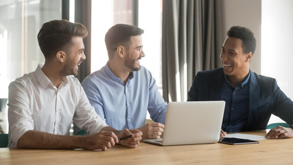 Fototapeta premium Friendly smiling business team discussing project ideas in office