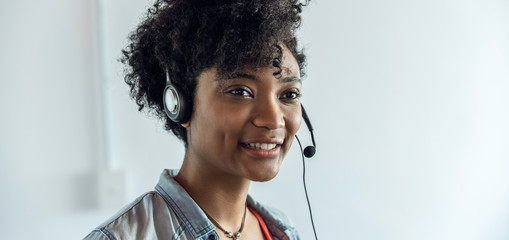 Close-up of young businesswoman wearing headset