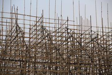 worker hide in the bamboo scaffolding for chinese opera stage