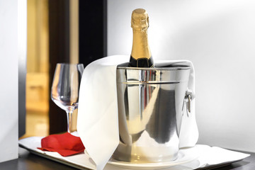 Iced bucket with champagne bottle and glasses