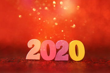 Holiday image of New Year 2020 concept. Wooden number and sparkling background