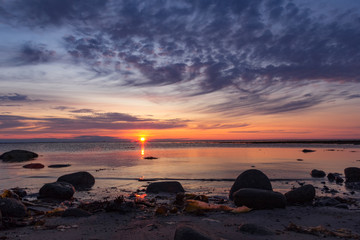 Fototapeta na wymiar Beautiful sunset on the White Sea, on the Solovetsky Islands, Russia. Calm, peaceful nature. Can be used as a screensaver, wallpaper, postcard.