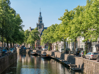 Canal and church tower in Gouda, Holland - obrazy, fototapety, plakaty