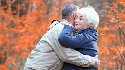 Fototapeta premium Senior woman hugs man and smiling