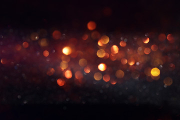 background of abstract glitter lights. gold and black. de focused