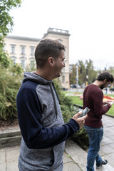 Young man using his mobile in the street