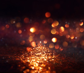 background of abstract glitter lights. gold and black. de focused