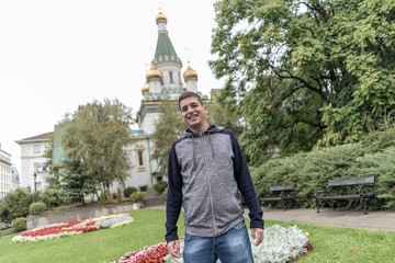 Obraz premium Young man smiling in the streets of Sofia .