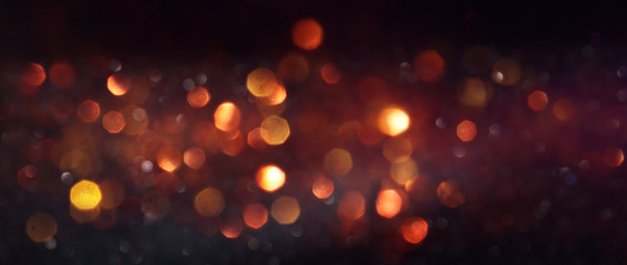 background of abstract glitter lights. gold and black. de focused. banner