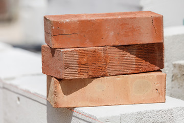 Stack of orange bricks on construction site