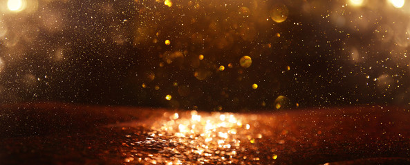 background of abstract glitter lights. gold and black. de focused. banner