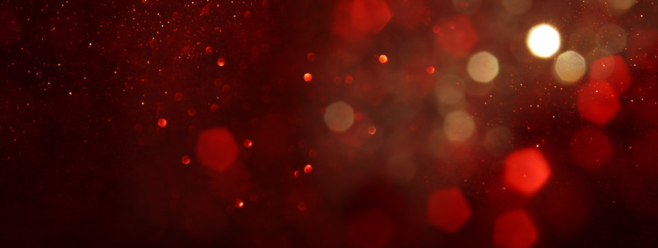 background of abstract red, gold and black glitter lights. defocused. banner