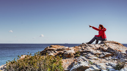 Tourist woman on sea cliffs in Spain