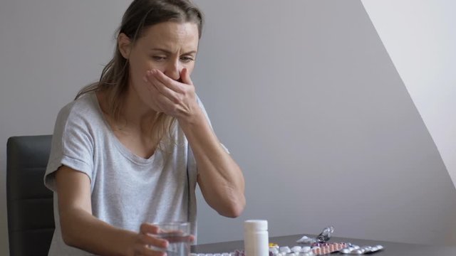 Depressed women with mental disorder with lot drug in hand wants to commit suicide sitting at home
